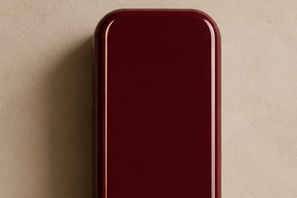 Closed by default: A solid burgundy cover blocks the lens and flash.