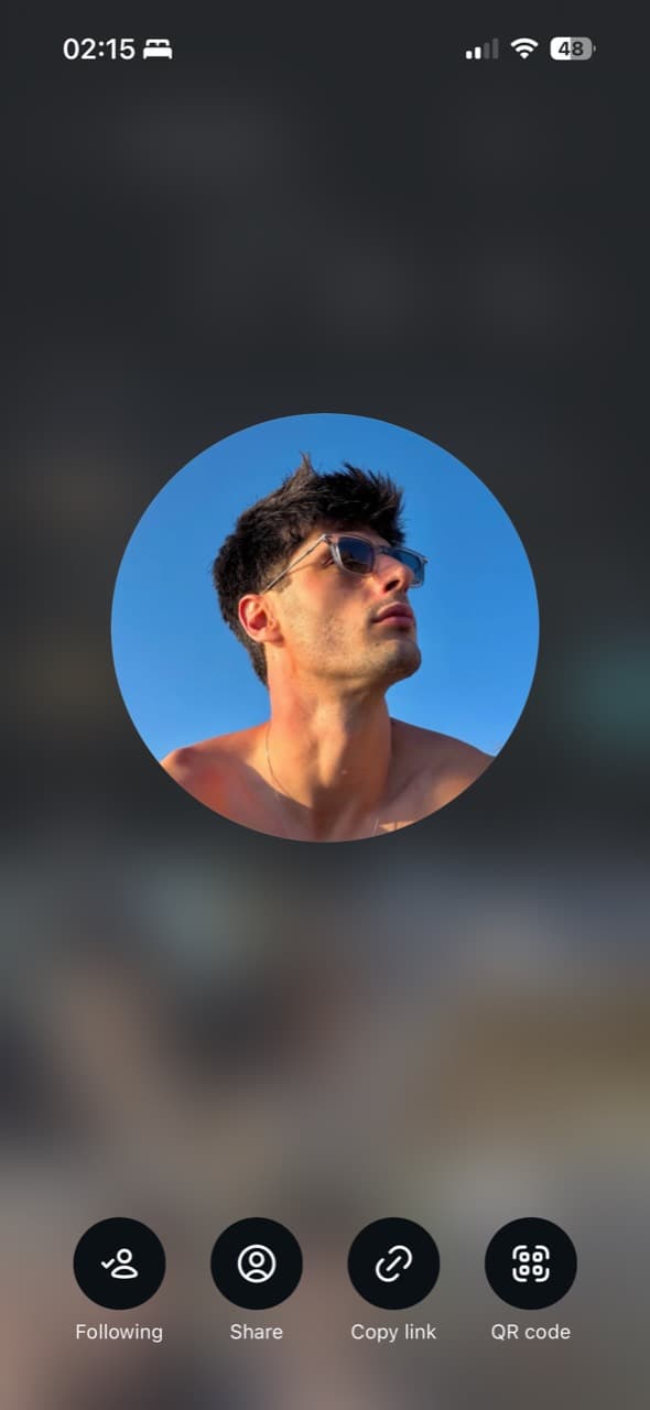 Portrait of Nico wearing sunglasses against a blue sky